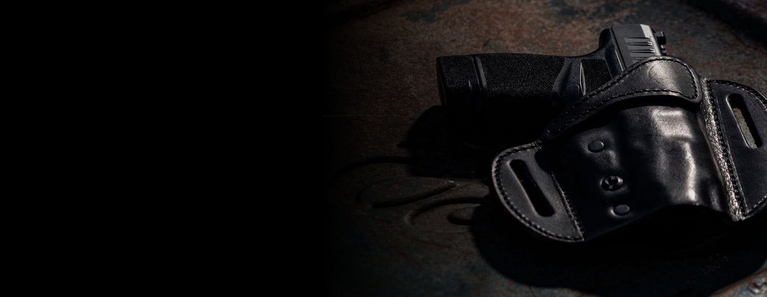 Black gun holster with a gun inside on a dark background