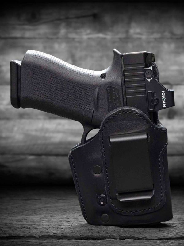 Urban Carry black leather IWB holster with a secure clip and pistol, designed for discreet concealed carry and retention.