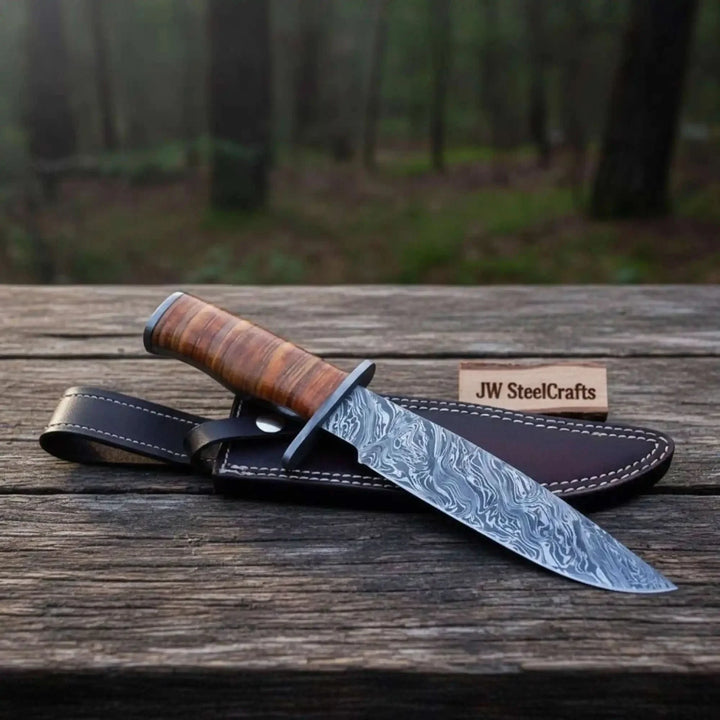 Knife with wooden handle and leather sheath on a wooden surface with a forest background