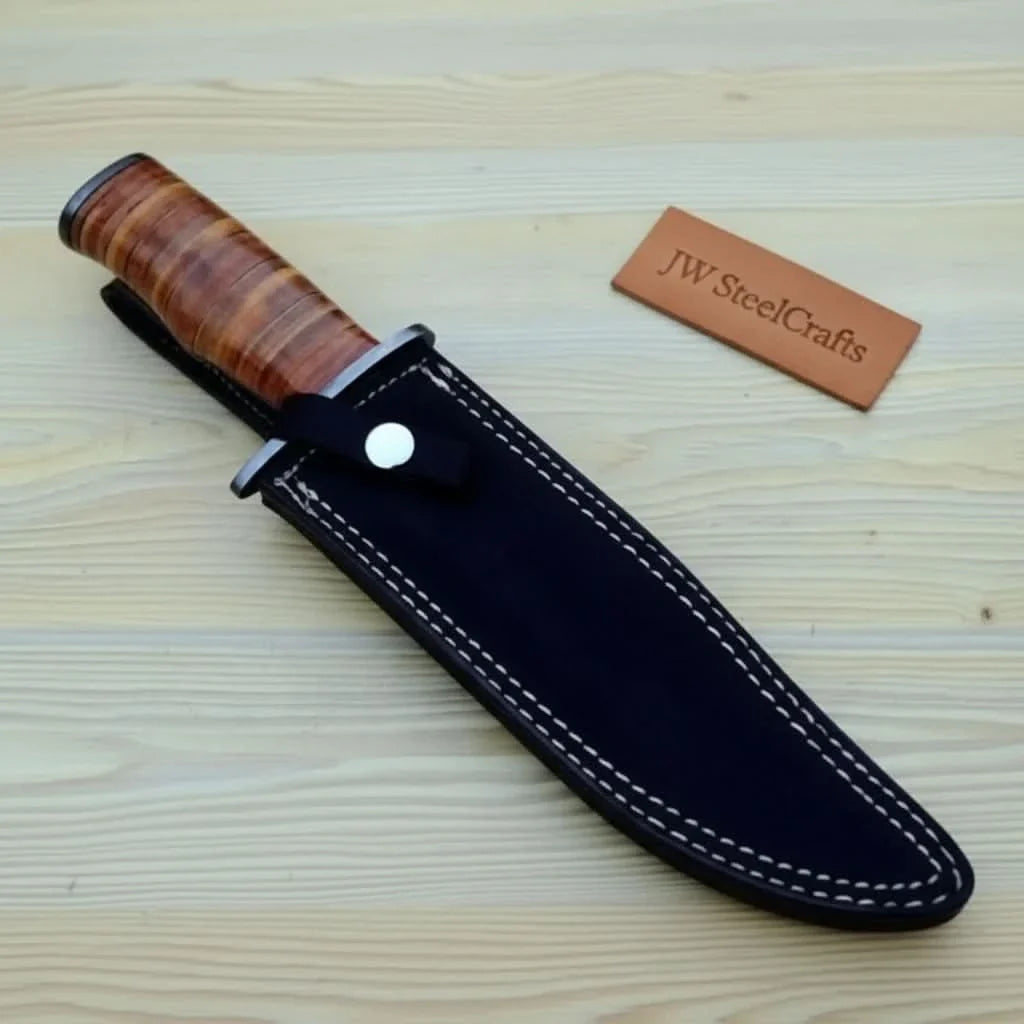 Knife with wooden handle and black sheath on a wooden surface with 'JW SteelCrafts' branding.