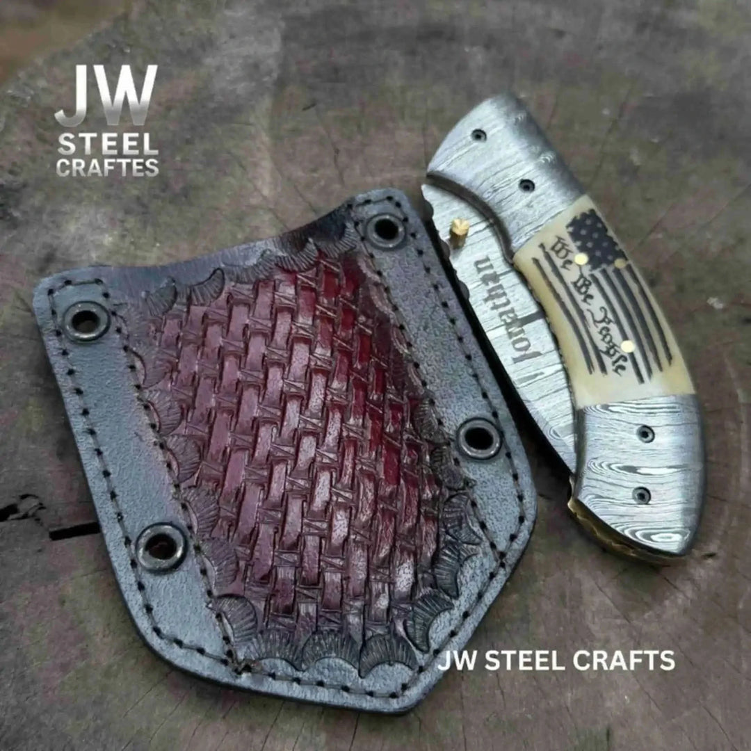 Knife with leather sheath on a textured surface, branded 'JW Steel Crafts'.