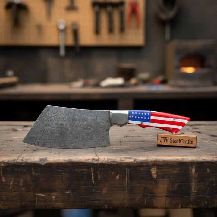 Cleaver knife with a decorative blade on a wooden block and patriotic handle, branded 'JW SteelCrafts'.