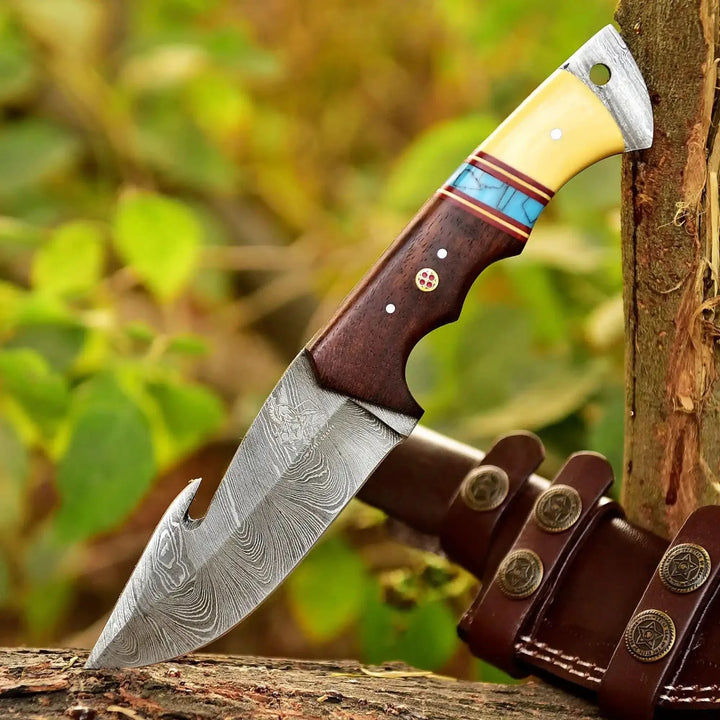 Decorative knife with a wooden handle and leather sheath against a natural background