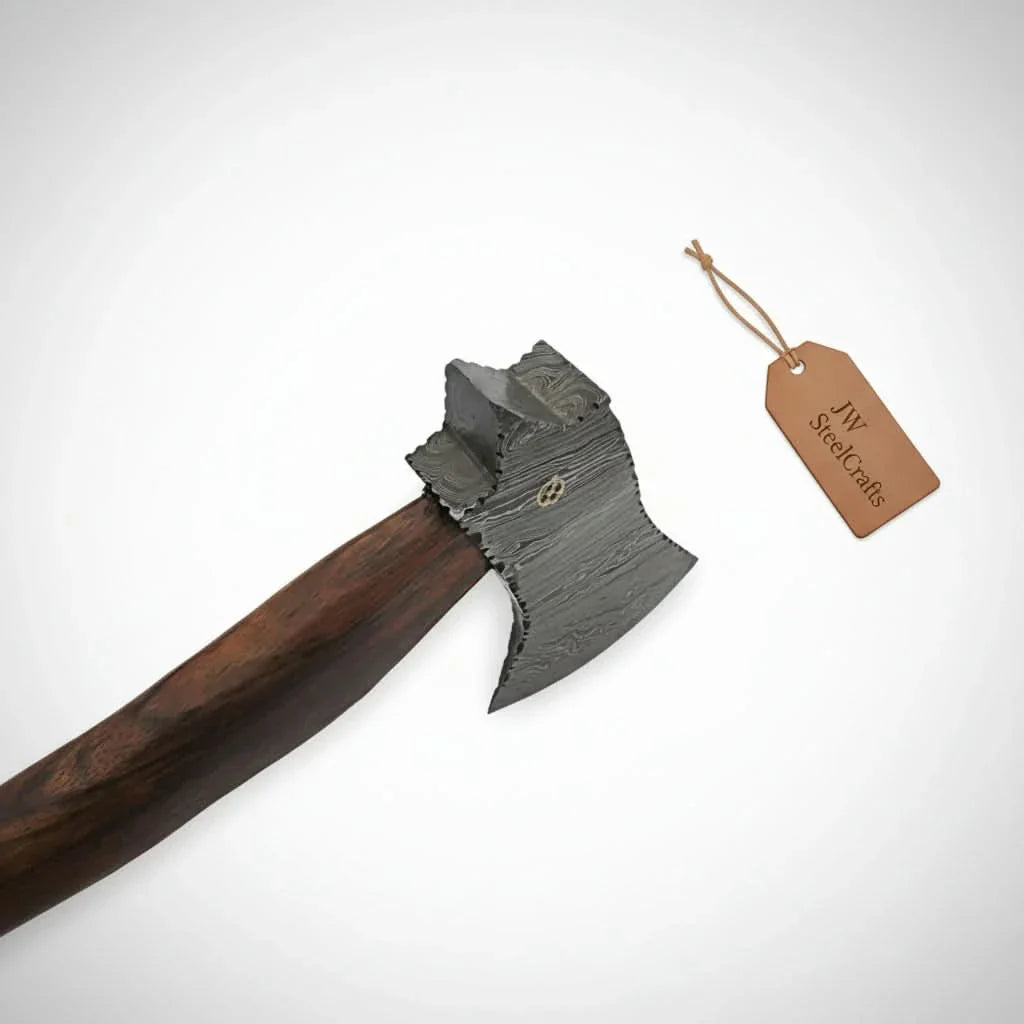 Wooden-handled axe with a decorative blade on a white background